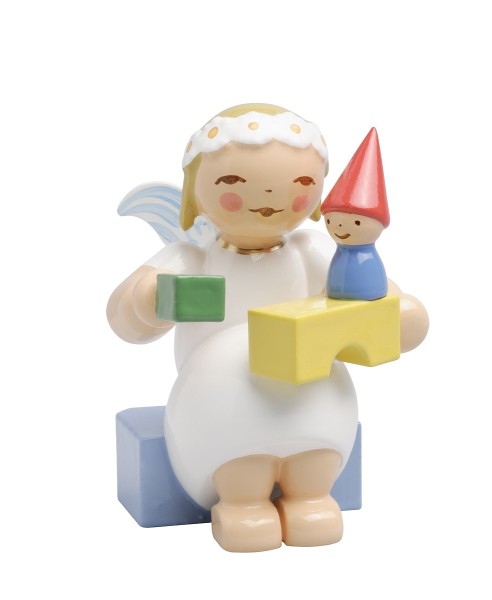 Marguerite angel, sitting, with building blocks